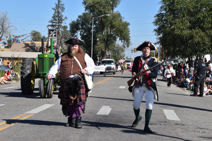 Fort Lupton's Trappers Day parade brought out all sorts of historical reenactors. Here Travis Butterworth, dressed as a soldier from the 1740 Scottish uprising, and Tom Wellborne dressed as a 1776 American Revolution soldier march along the parade route.